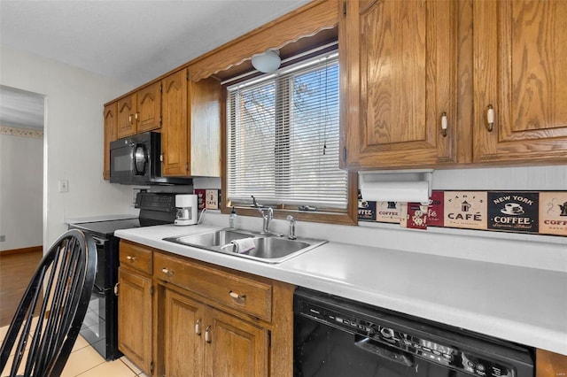 2013 Lee Dr, Cape Girardeau, MO 63701 - kitchen with black appliances, a sink, light countertops, brown cabinets, and light tile patterned floors