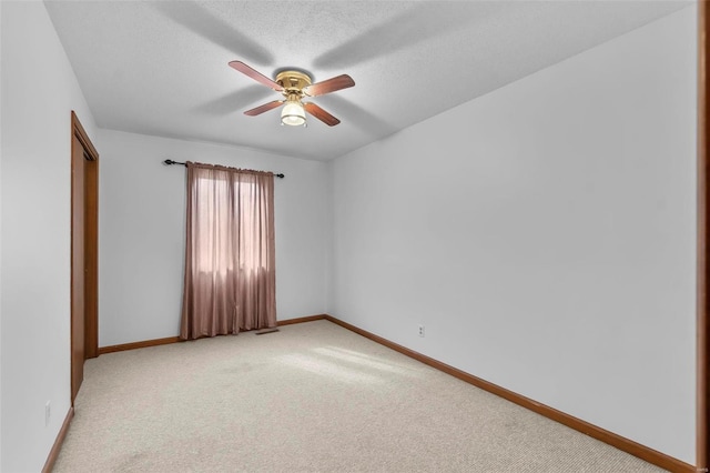 2013 Lee Dr, Cape Girardeau, MO 63701 - empty room featuring a ceiling fan, light carpet, baseboards, and a textured ceiling