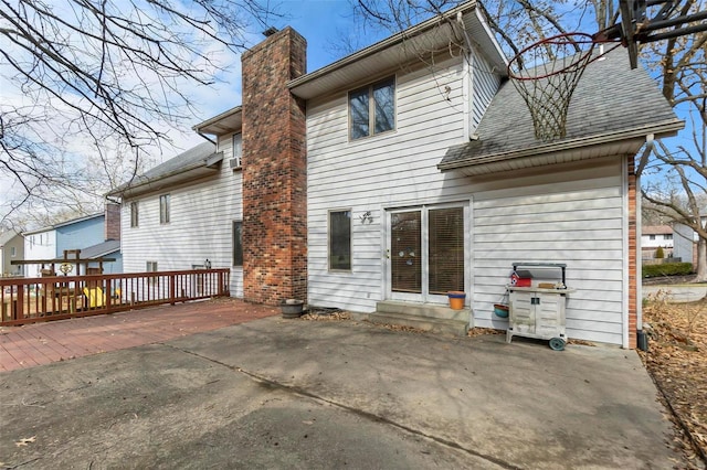 2013 Lee Dr, Cape Girardeau, MO 63701 - back of property featuring a chimney, a patio area, and roof with shingles