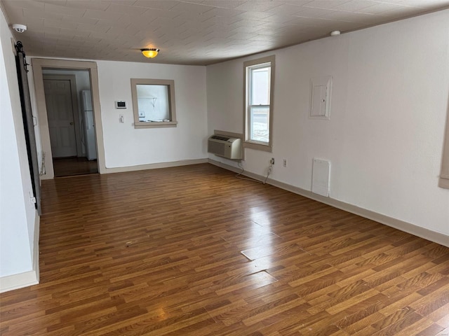 1355 Springfield Rd, Lebanon, MO 65536 - spare room featuring a wall mounted AC, wood finished floors, and baseboards