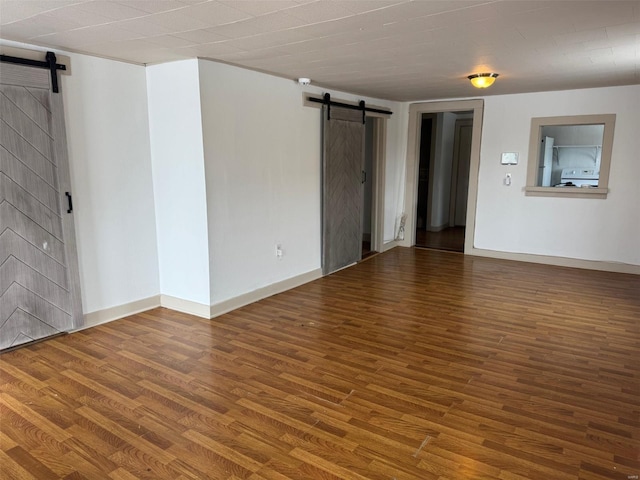 1355 Springfield Rd, Lebanon, MO 65536 - spare room with a barn door, wood finished floors, and baseboards