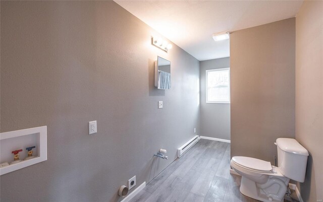 308 S Frisco St, Crocker, MO 65452 - bathroom with baseboard heating, toilet, wood finished floors, and baseboards