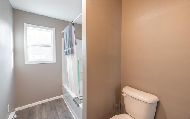 308 S Frisco St, Crocker, MO 65452 - bathroom featuring toilet, wood finished floors, shower / bathtub combination with curtain, and baseboards