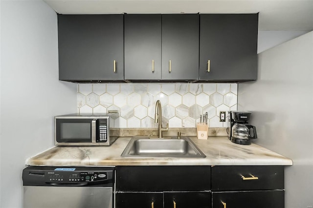 1523 S 10th St Unit 207, Saint Louis, MO 63101 - kitchen with appliances with stainless steel finishes, a sink, and dark cabinets