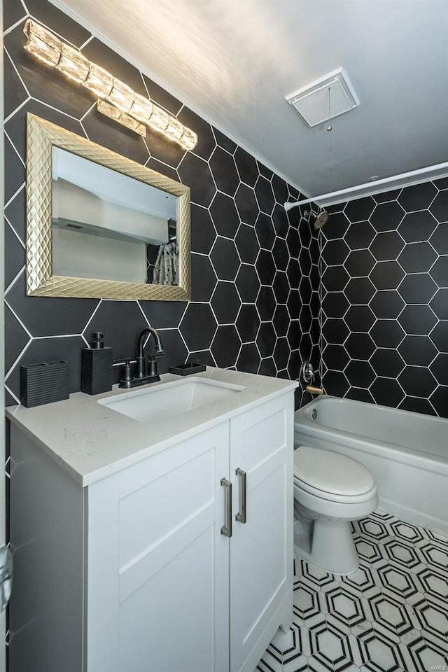1523 S 10th St Unit 207, Saint Louis, MO 63101 - bathroom with tile walls, toilet, shower / bath combination, vanity, and tasteful backsplash