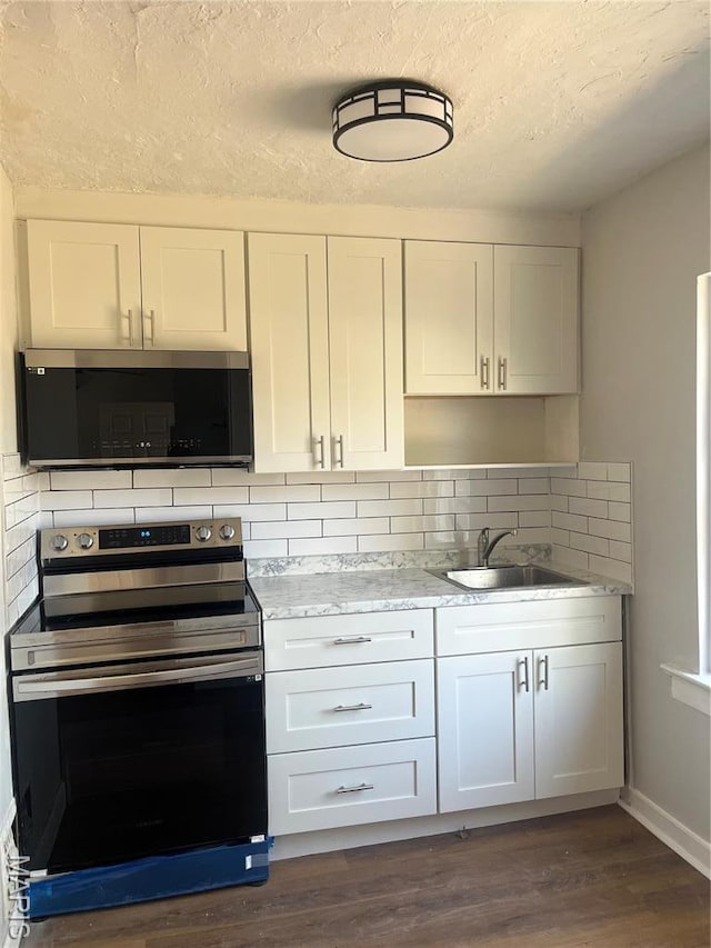 9411 Muriel Ave, Saint Louis, MO 63114 - kitchen featuring stainless steel electric stove, a sink, backsplash, a textured ceiling, and white cabinetry