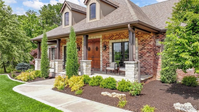 130 Foristell Ridge Ct, Foristell, MO 63348 - view of front of house featuring covered porch, brick siding, and a shingled roof