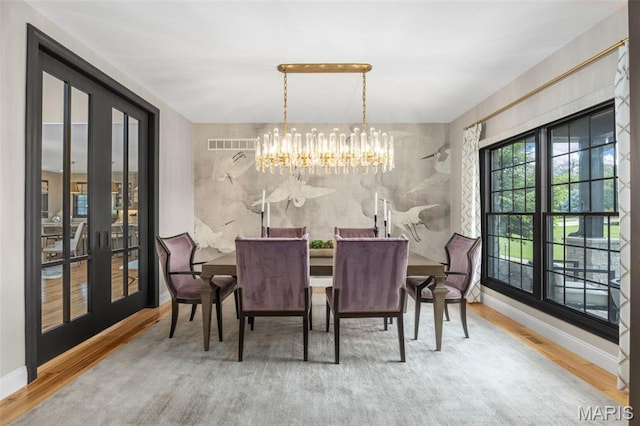 130 Foristell Ridge Ct, Foristell, MO 63348 - dining room featuring wood finished floors, a chandelier, and french doors