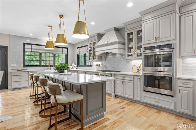 130 Foristell Ridge Ct, Foristell, MO 63348 - kitchen featuring stainless steel appliances, custom range hood, gray cabinets, backsplash, and recessed lighting