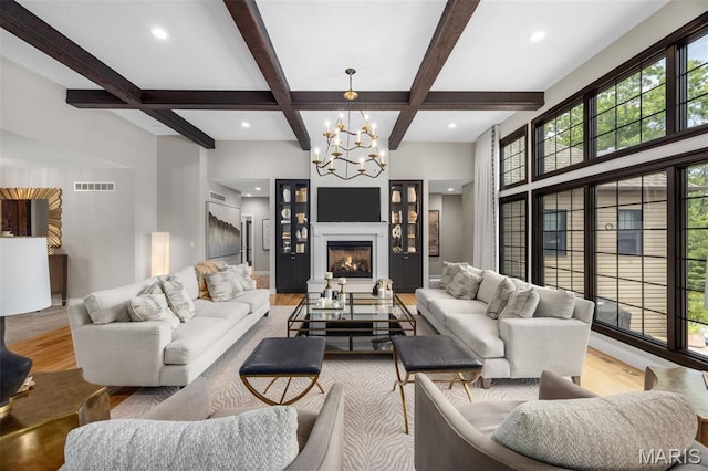 130 Foristell Ridge Ct, Foristell, MO 63348 - living room featuring a chandelier, plenty of natural light, coffered ceiling, wood finished floors, and beam ceiling