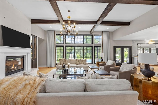 130 Foristell Ridge Ct, Foristell, MO 63348 - living area featuring a chandelier, a glass covered fireplace, light wood finished floors, coffered ceiling, and beamed ceiling