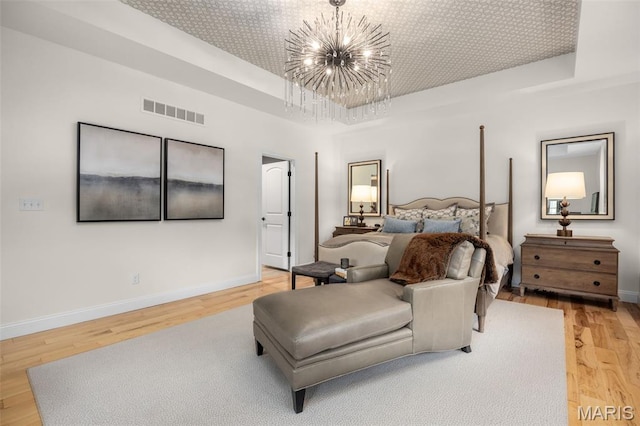 130 Foristell Ridge Ct, Foristell, MO 63348 - bedroom featuring a raised ceiling, a chandelier, and light wood finished floors