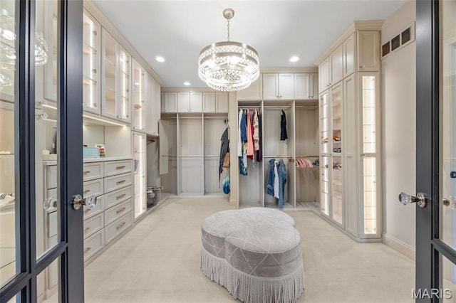 130 Foristell Ridge Ct, Foristell, MO 63348 - walk in closet with light colored carpet, a chandelier, and french doors