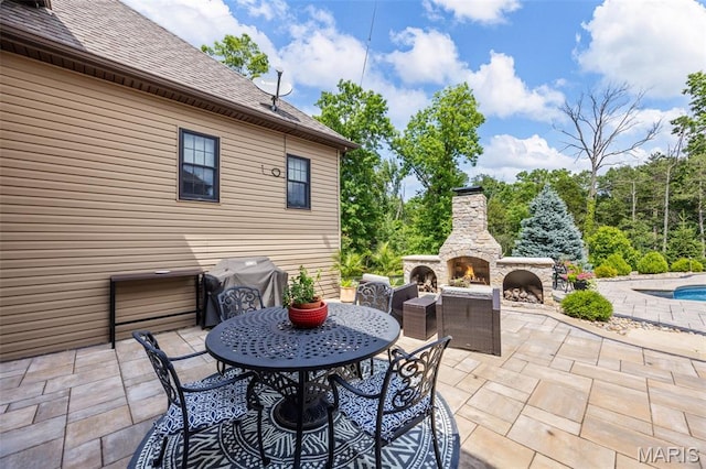 130 Foristell Ridge Ct, Foristell, MO 63348 - view of patio / terrace with an outdoor stone fireplace and a grill