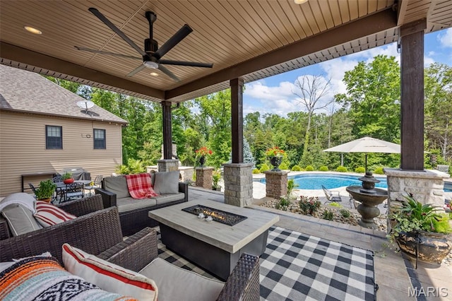 130 Foristell Ridge Ct, Foristell, MO 63348 - view of patio / terrace featuring an outdoor pool, an outdoor living space with a fire pit, a ceiling fan, and view of wooded area