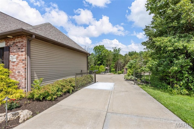 130 Foristell Ridge Ct, Foristell, MO 63348 - view of side of home with a shingled roof and brick siding