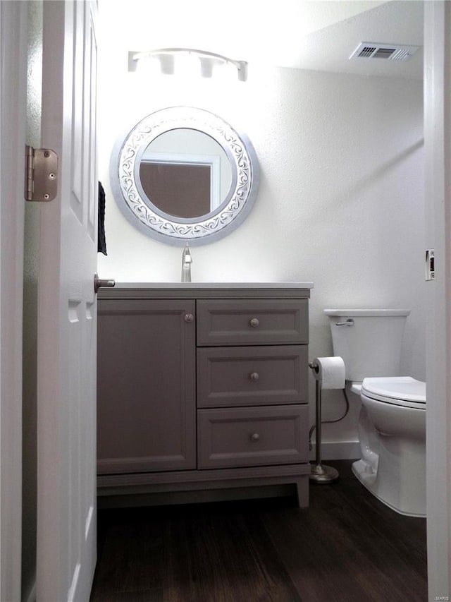 1002 Cypress Dr, Rolla, MO 65401 - bathroom featuring toilet, wood finished floors, vanity, and baseboards