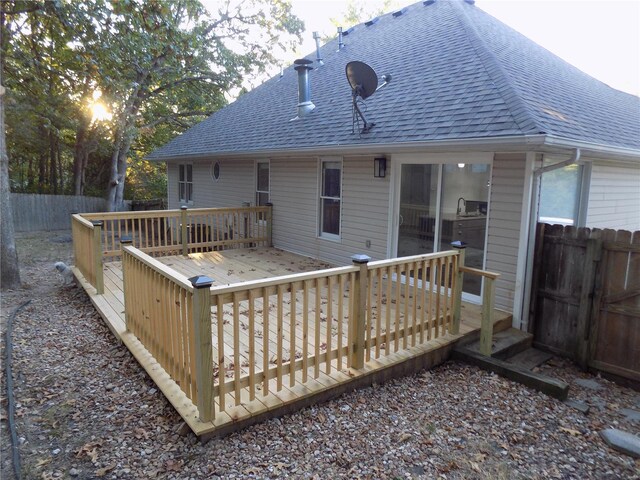 1002 Cypress Dr, Rolla, MO 65401 - rear view of house with roof with shingles, a wooden deck, and fence