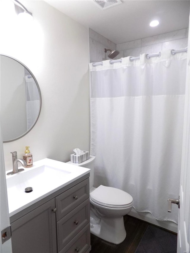 1002 Cypress Dr, Rolla, MO 65401 - full bath featuring vanity, toilet, shower / bathtub combination with curtain, and wood finished floors