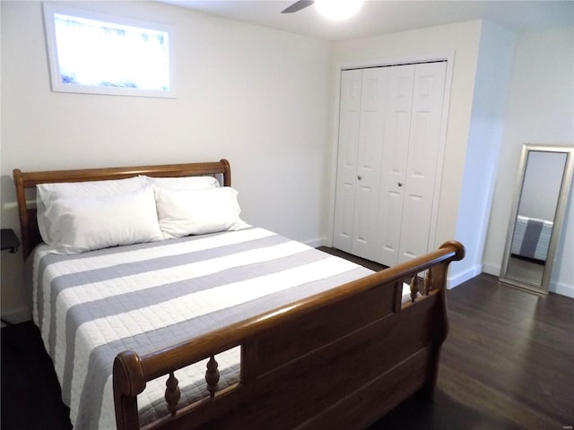 1002 Cypress Dr, Rolla, MO 65401 - bedroom featuring dark wood-style flooring, a closet, baseboards, and a ceiling fan