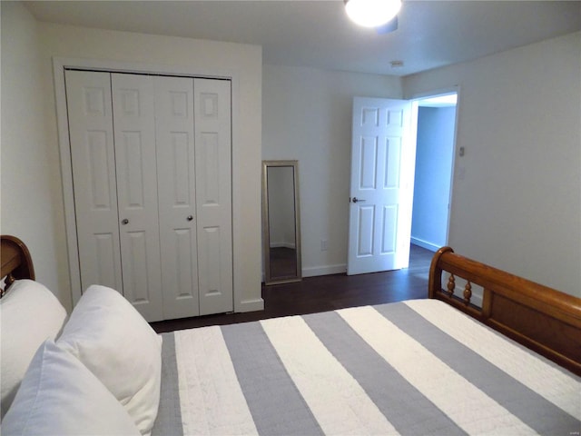 1002 Cypress Dr, Rolla, MO 65401 - bedroom with dark wood finished floors, a closet, and baseboards