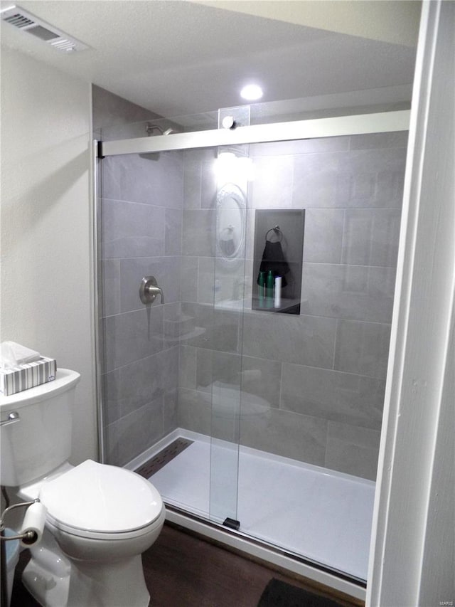 1002 Cypress Dr, Rolla, MO 65401 - bathroom with toilet, a shower stall, and wood finished floors