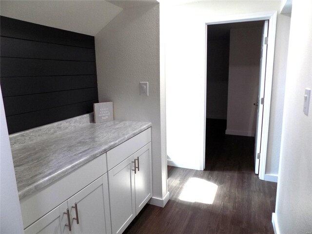 1002 Cypress Dr, Rolla, MO 65401 - hallway with dark wood-type flooring and baseboards