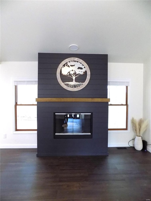 1002 Cypress Dr, Rolla, MO 65401 - detailed view of a large fireplace, baseboards, and wood finished floors