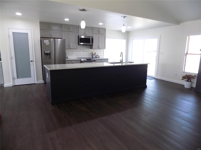 1002 Cypress Dr, Rolla, MO 65401 - kitchen with appliances with stainless steel finishes, a sink, gray cabinets, baseboards, and dark wood-style floors