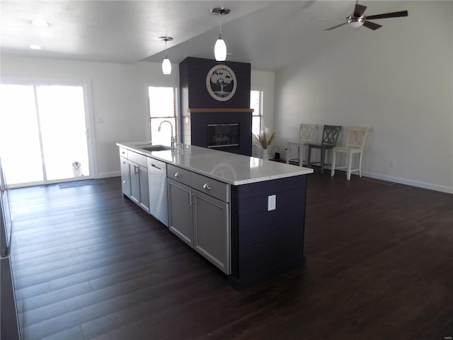 1002 Cypress Dr, Rolla, MO 65401 - kitchen featuring a sink, dishwashing machine, a large fireplace, dark wood-type flooring, and lofted ceiling