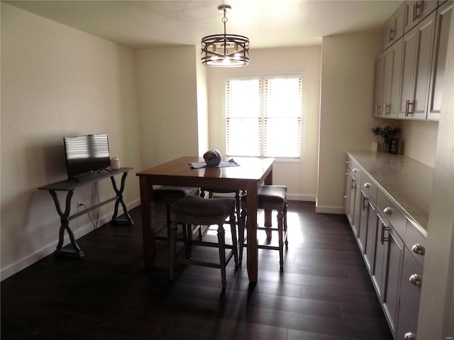 1002 Cypress Dr, Rolla, MO 65401 - dining area featuring baseboards, dark wood finished floors, and a chandelier