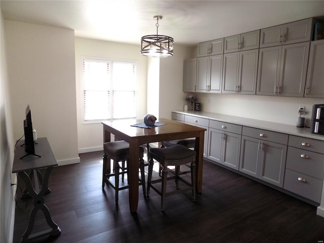 1002 Cypress Dr, Rolla, MO 65401 - dining area featuring dark wood-type flooring, baseboards, and a chandelier