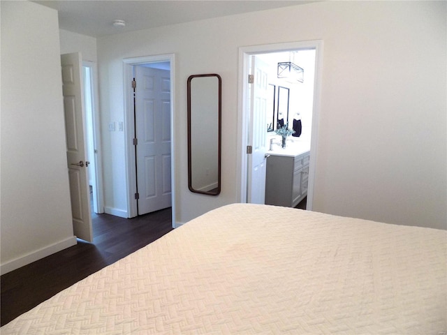 1002 Cypress Dr, Rolla, MO 65401 - bedroom featuring dark wood-style floors, baseboards, and ensuite bathroom