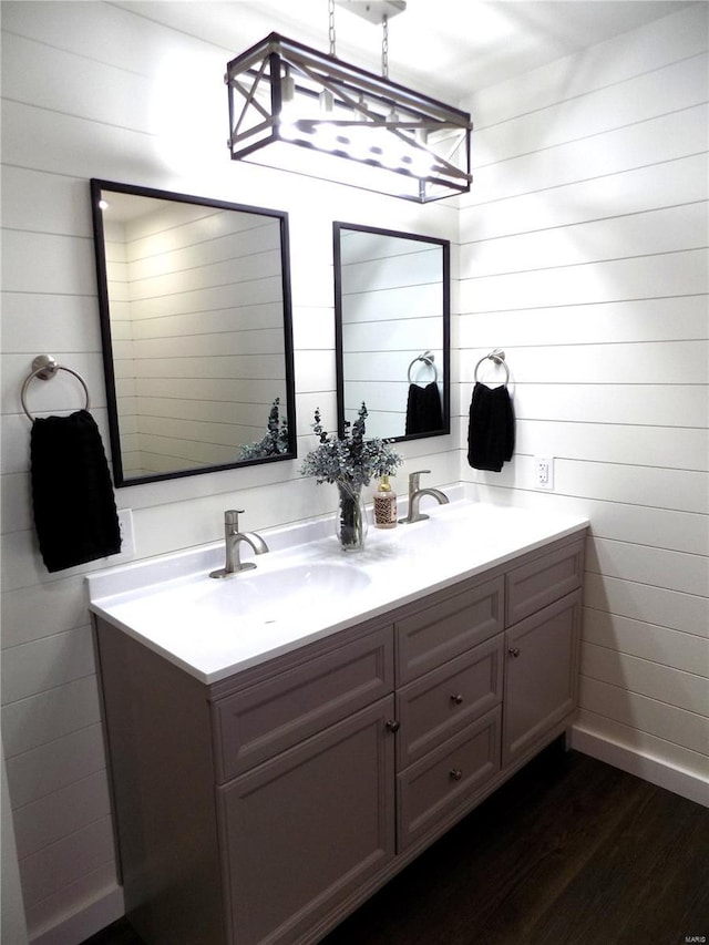 1002 Cypress Dr, Rolla, MO 65401 - bathroom featuring wood finished floors and double vanity
