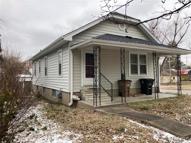 view of front of home with entry steps and roof with shingles