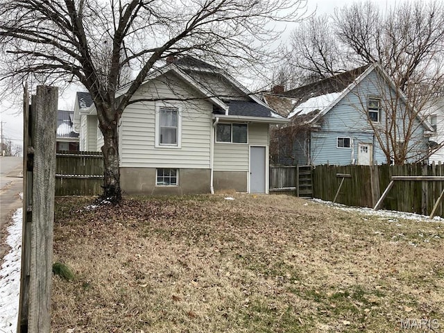 back of property featuring fence
