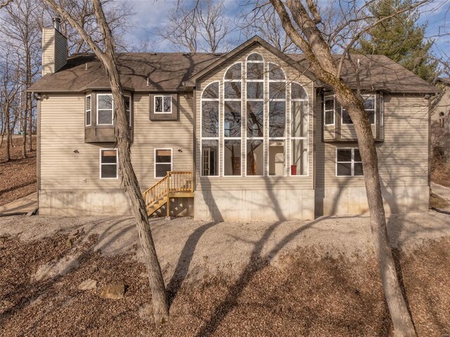 back of property featuring a chimney