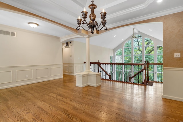 unfurnished room with a ceiling fan, wainscoting, wood finished floors, a chandelier, and vaulted ceiling