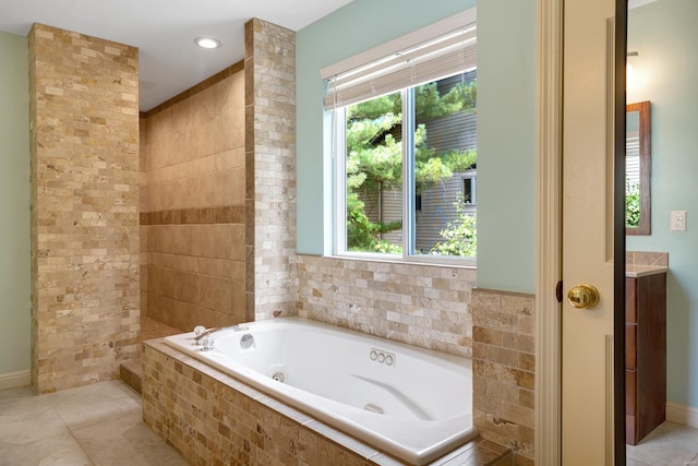 full bath with a whirlpool tub, plenty of natural light, and tile patterned flooring