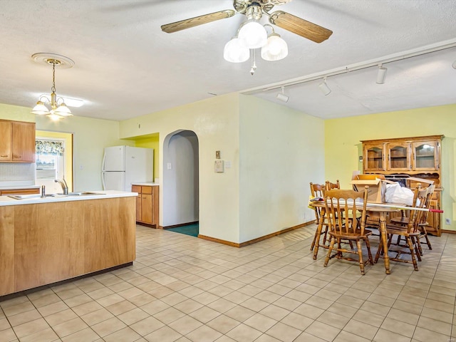 9355 State Route 3, Red Bud, IL 62278 - dining space featuring arched walkways, track lighting, ceiling fan, a textured ceiling, and light tile patterned flooring