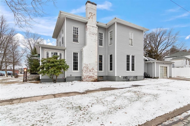 821 N State St, Litchfield, IL 62056 - snow covered back of property with a chimney