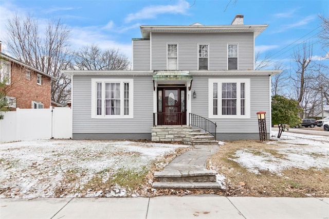821 N State St, Litchfield, IL 62056 - view of front facade with fence and a chimney