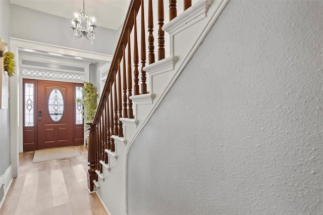 821 N State St, Litchfield, IL 62056 - foyer with a chandelier, stairs, light wood-type flooring, and baseboards