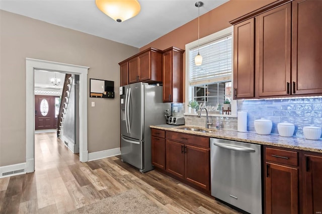 821 N State St, Litchfield, IL 62056 - kitchen with stainless steel appliances, a sink, backsplash, and light stone counters