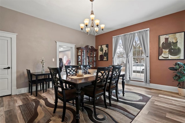821 N State St, Litchfield, IL 62056 - dining space featuring a chandelier, wood finished floors, and baseboards