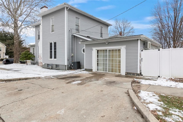 821 N State St, Litchfield, IL 62056 - snow covered back of property with a chimney and fence