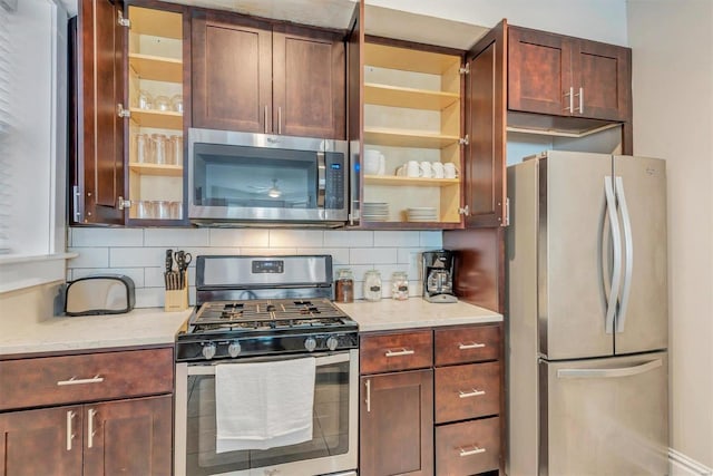920 Talmage, Saint Louis, MO 63110 - kitchen featuring stainless steel appliances, decorative backsplash, glass insert cabinets, and light stone counters