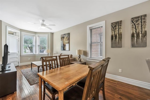 dining space with baseboards, a ceiling fan, and hardwood / wood-style flooring