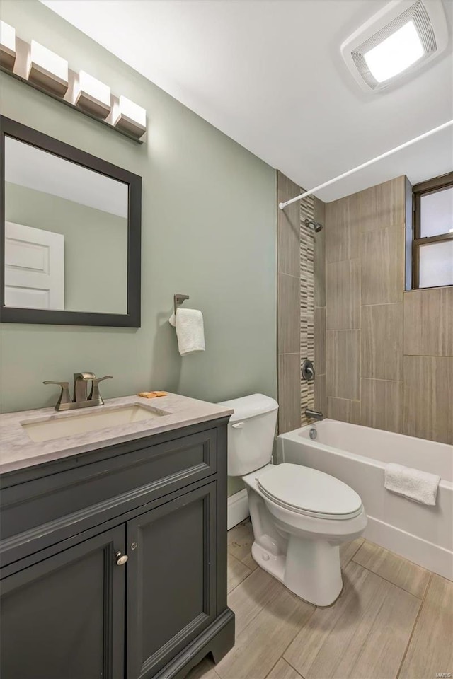 full bathroom featuring toilet, shower / bath combination, vanity, and wood finished floors