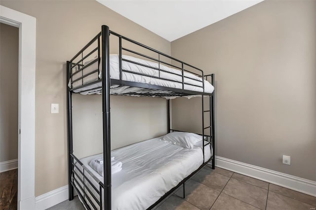 bedroom featuring baseboards and tile patterned floors